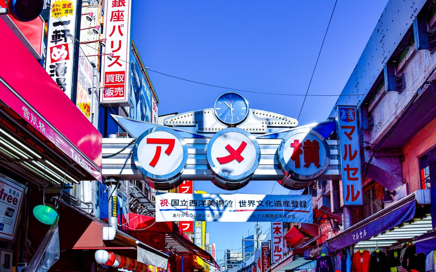 Vibrant street market scene in Japan with colorful signage and busy atmosphere