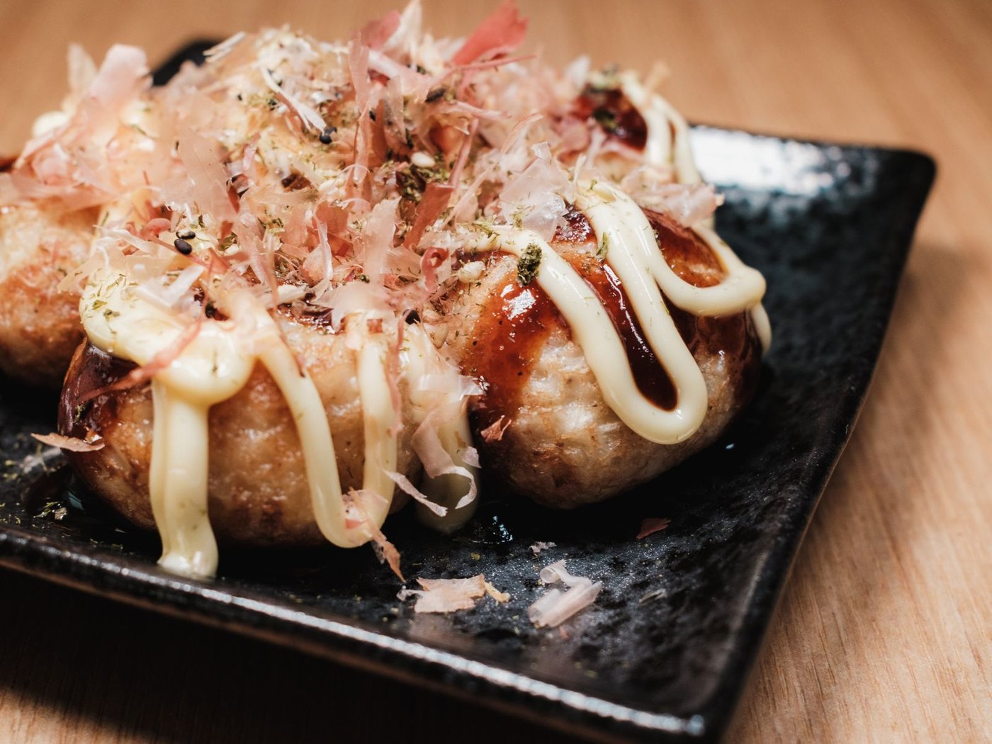 Takoyaki topped with mayonnaise, bonito flakes and spring onion