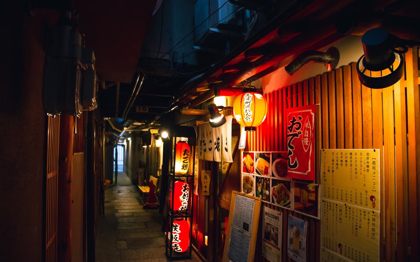 Red lanterns along a narrow izakaya alley in the evening