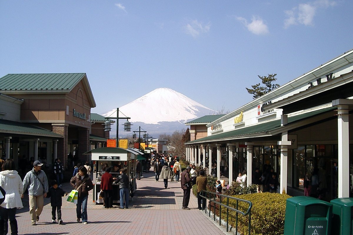 Shoppers on a wet walkway between the shops at Gotemba Premium Outlets