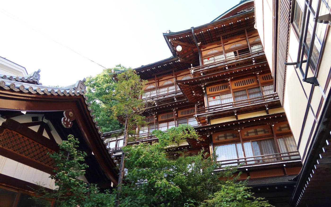 Wooden buildings of a traditional Japanese inn among trees