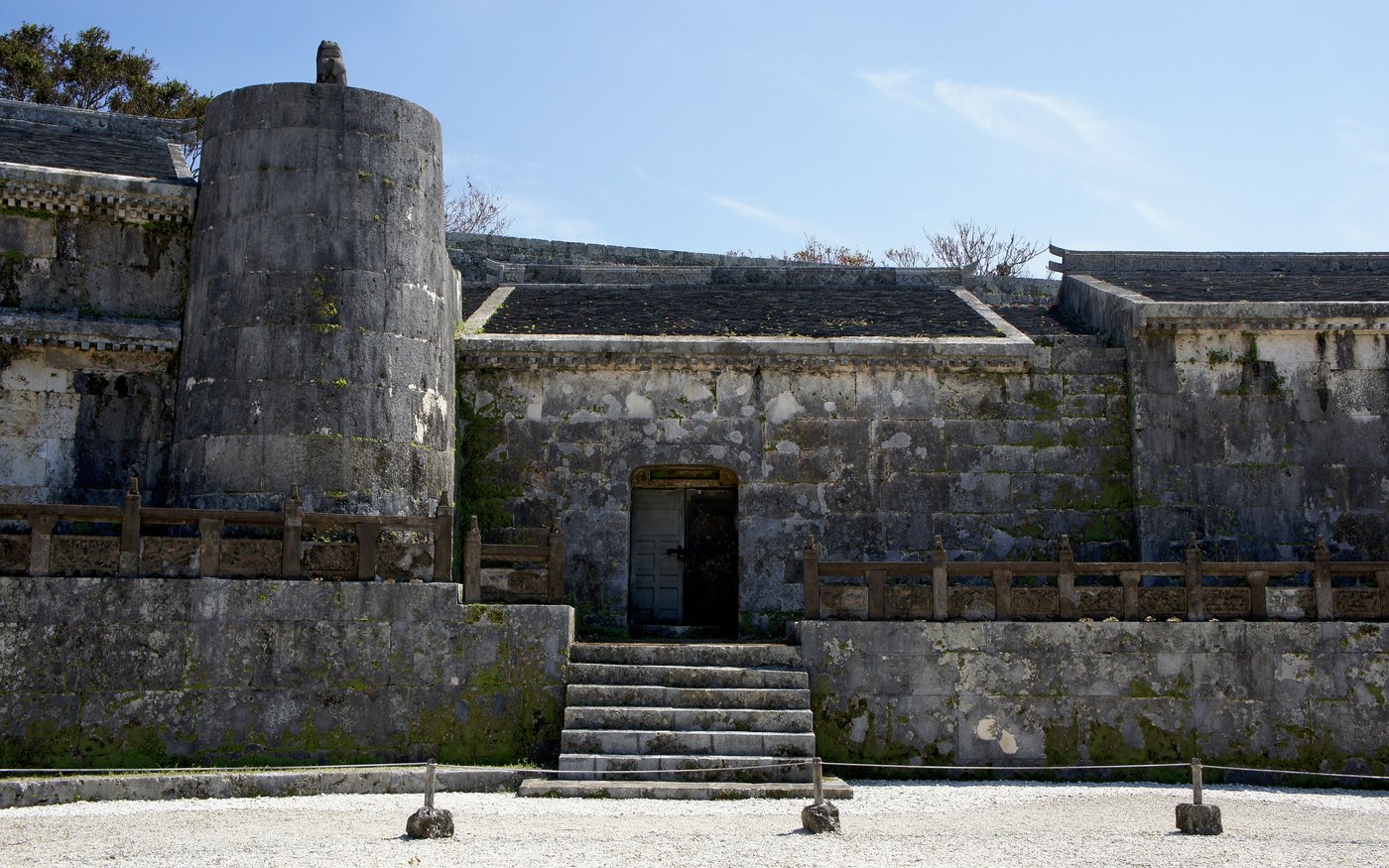 The stone wall and closed central chamber of Tamau-dun, the royal mausoleum, under a clear sky