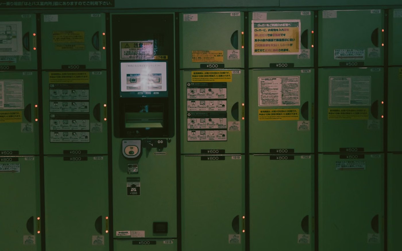 Green coin-operated lockers in a Japanese subway station