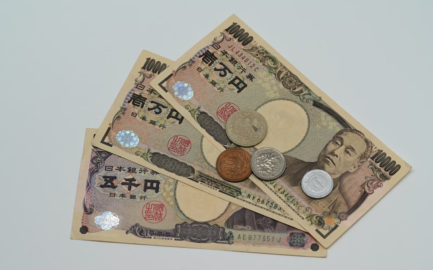 Japanese yen banknotes and coins arranged on a flat surface