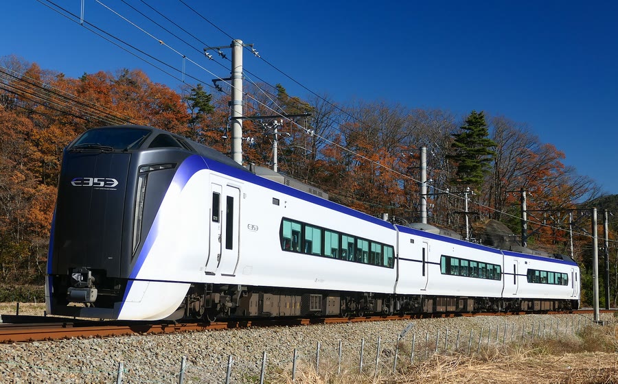 A JR East E353 series train, the type used on the Fuji Excursion, running through autumn trees