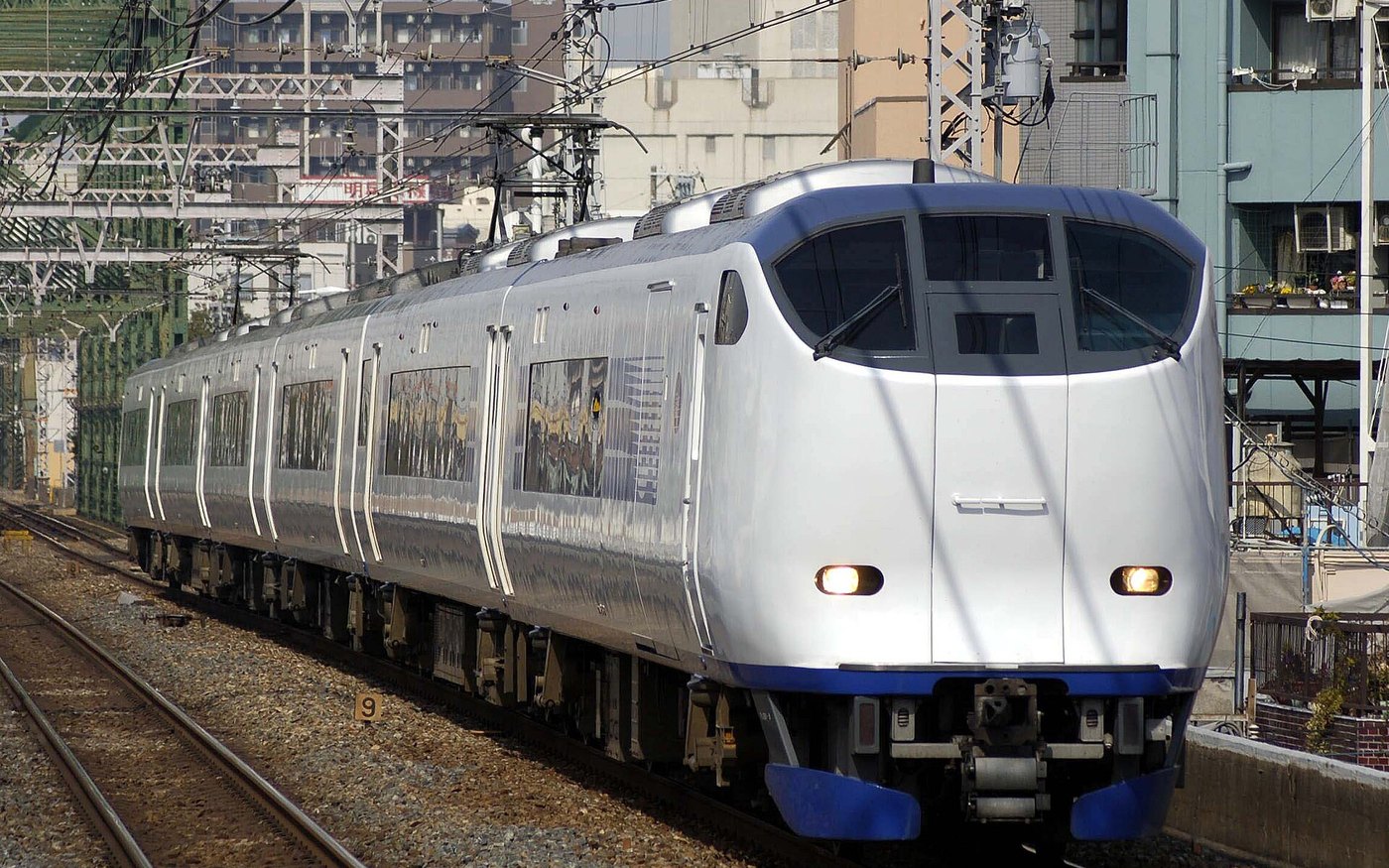 A JR Haruka limited express at a platform, white body with a blue stripe