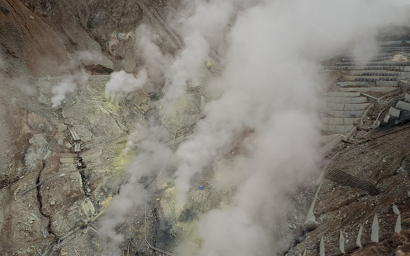 A ropeway gondola crossing the bare, steaming slopes of the Owakudani crater