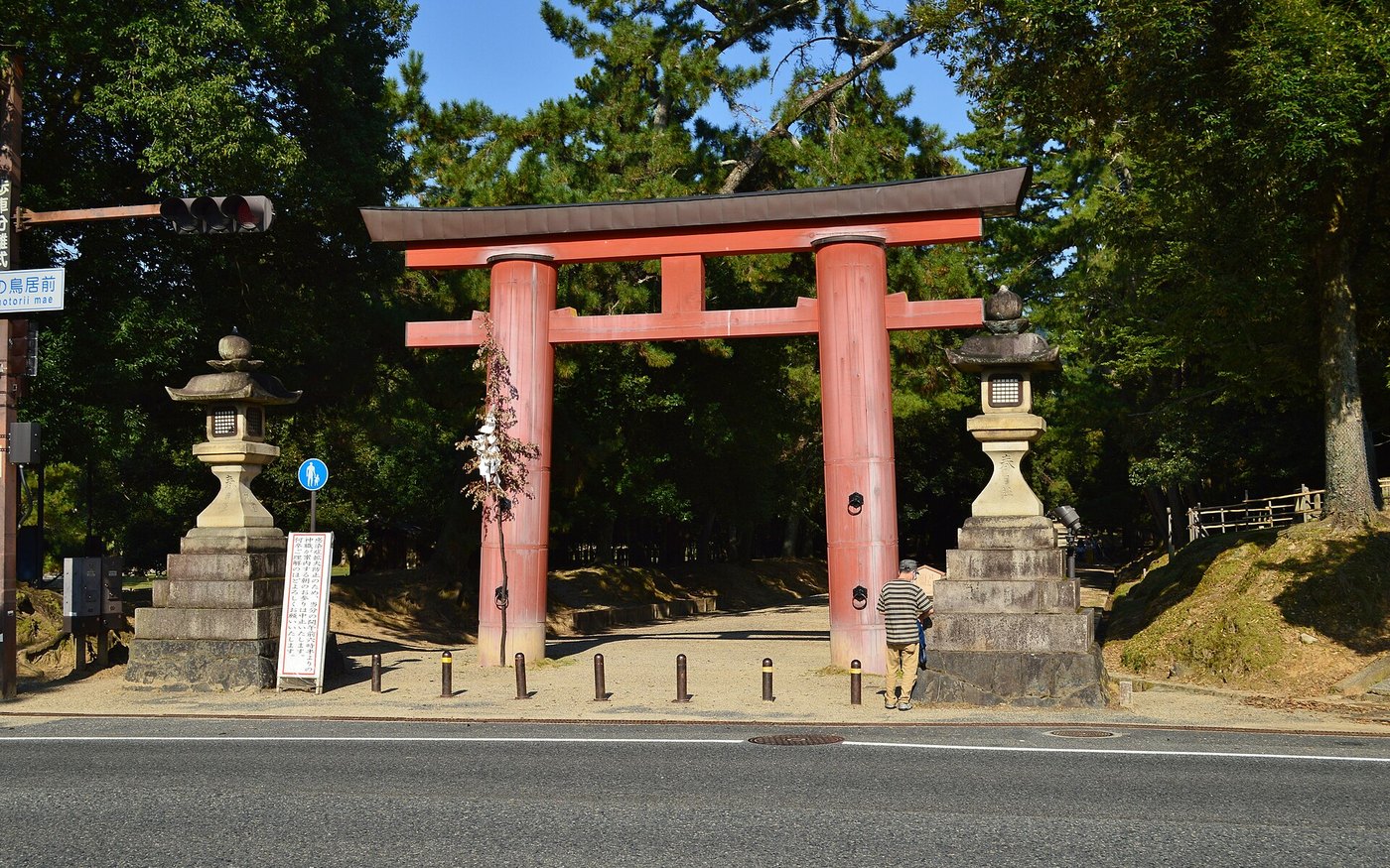 A red torii and stone lanterns on the approach to Kasuga Taisha in Nara