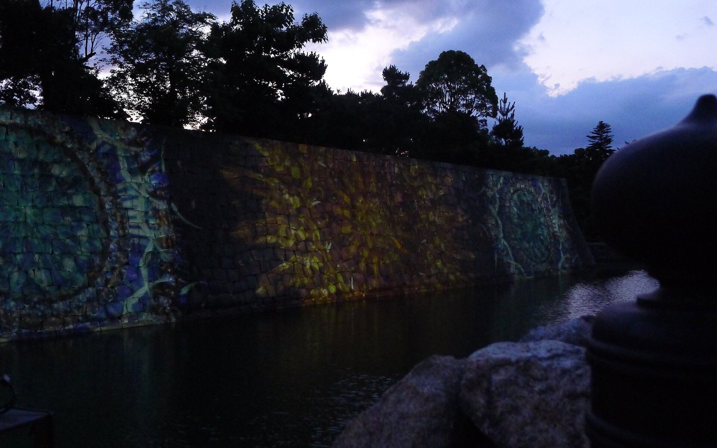 Projection mapping on the walls and moat of Nijo Castle at night, colour on the water