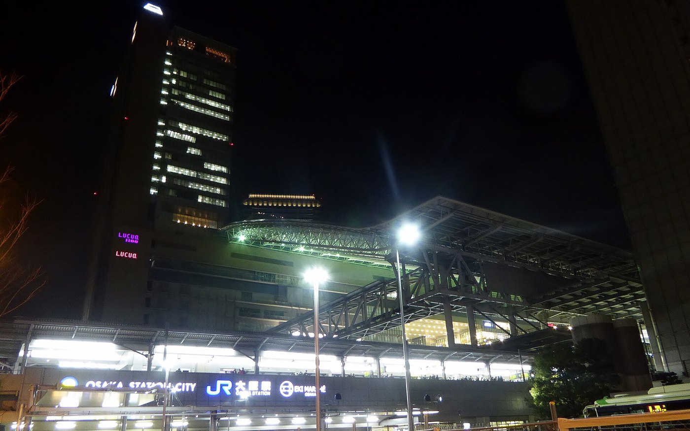 The Osaka Station City complex lit up at night, seen from the street below