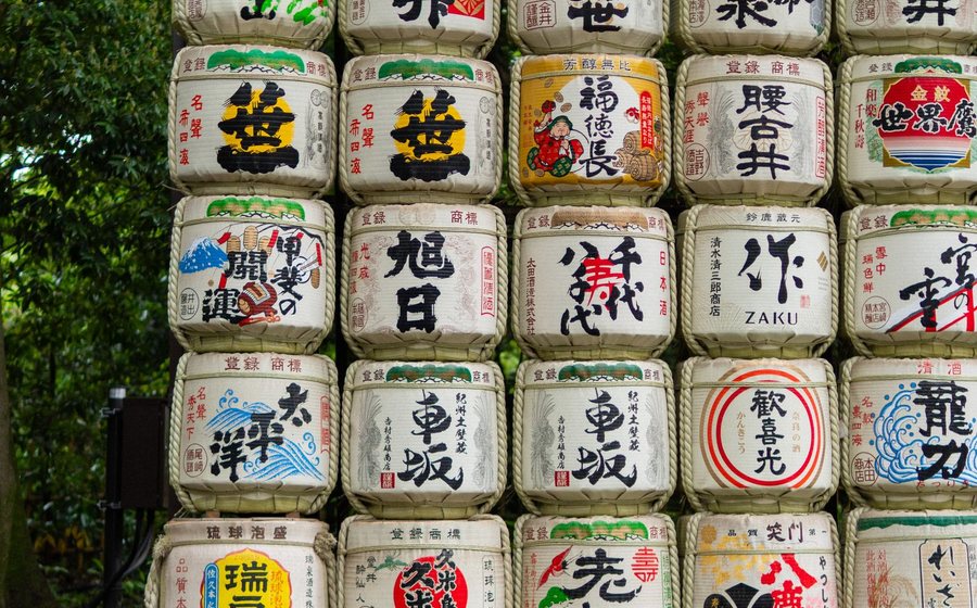 Rows of sake barrels stacked in a garden display