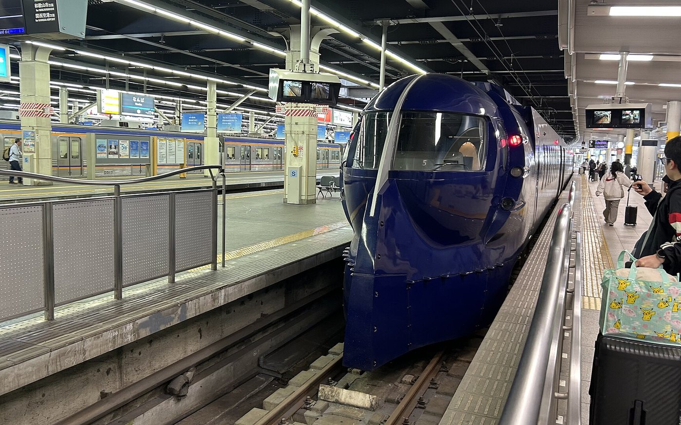 A blue Nankai Rapi:t limited express standing at a station platform