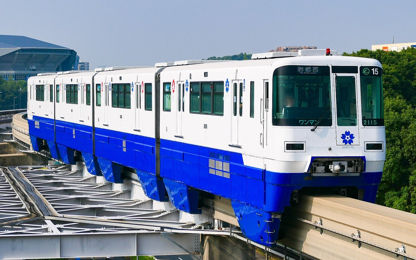 An Osaka Monorail train running on its elevated guideway above the road