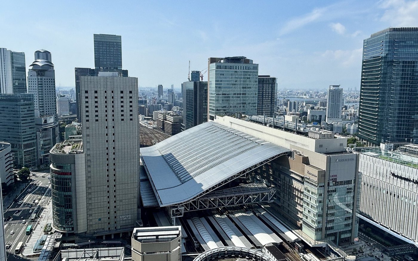 Platforms and the long station roof of JR Osaka Station seen from above in Umeda
