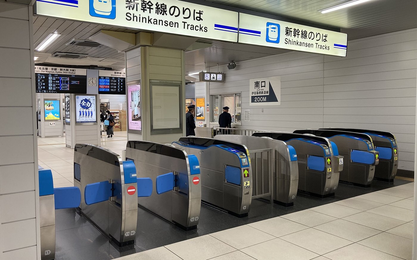A row of Shinkansen ticket gates with blue IC card readers at a Japanese station