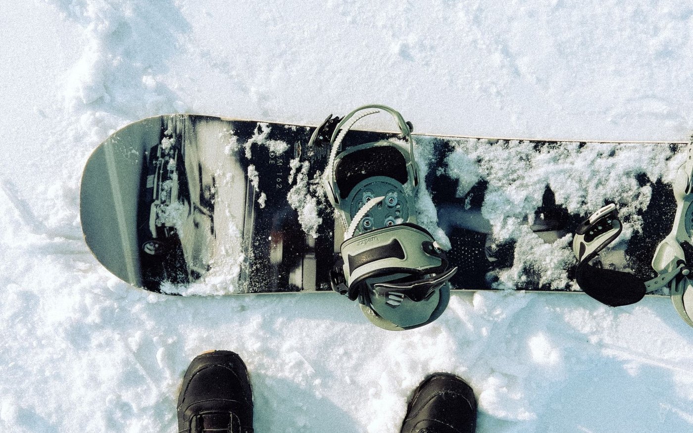 A snowboard and boots on the snow