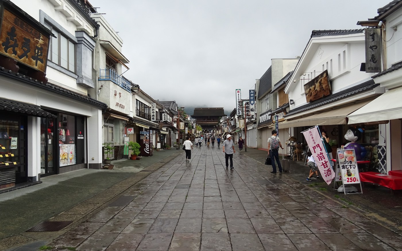 The stone-paved Nakamise approach to Zenko-ji lined with low wooden shopfronts