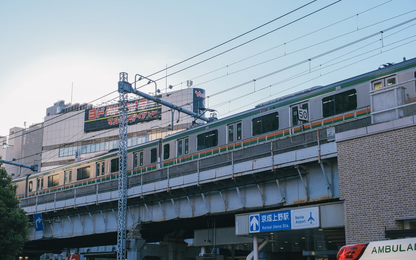 Train on elevated tracks near Keisei Ueno station in Tokyo, Japan during daytime